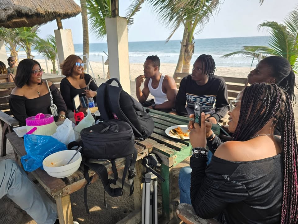 Campers sharing a meal at a table facing the ocean